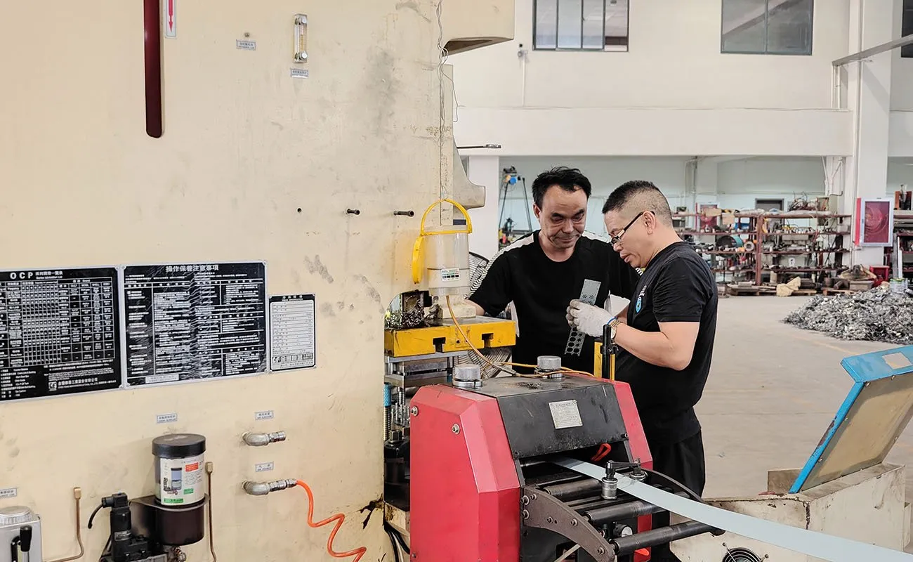 The employees are discussing the details of precision stamping.