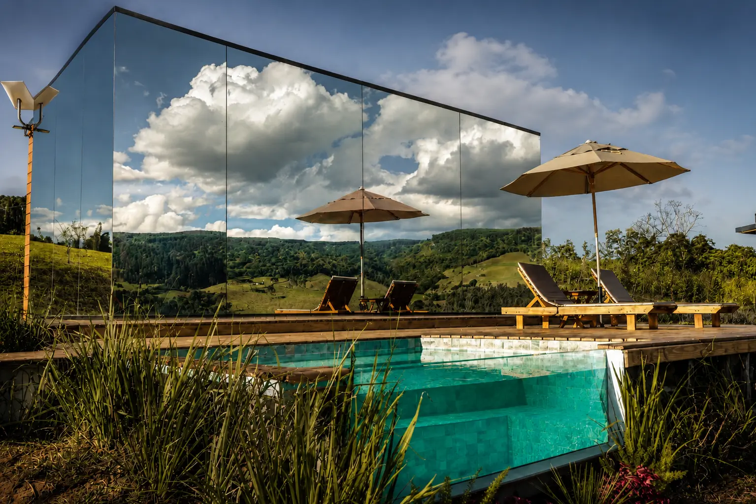 Mirror cabin overlooking a mountain pool