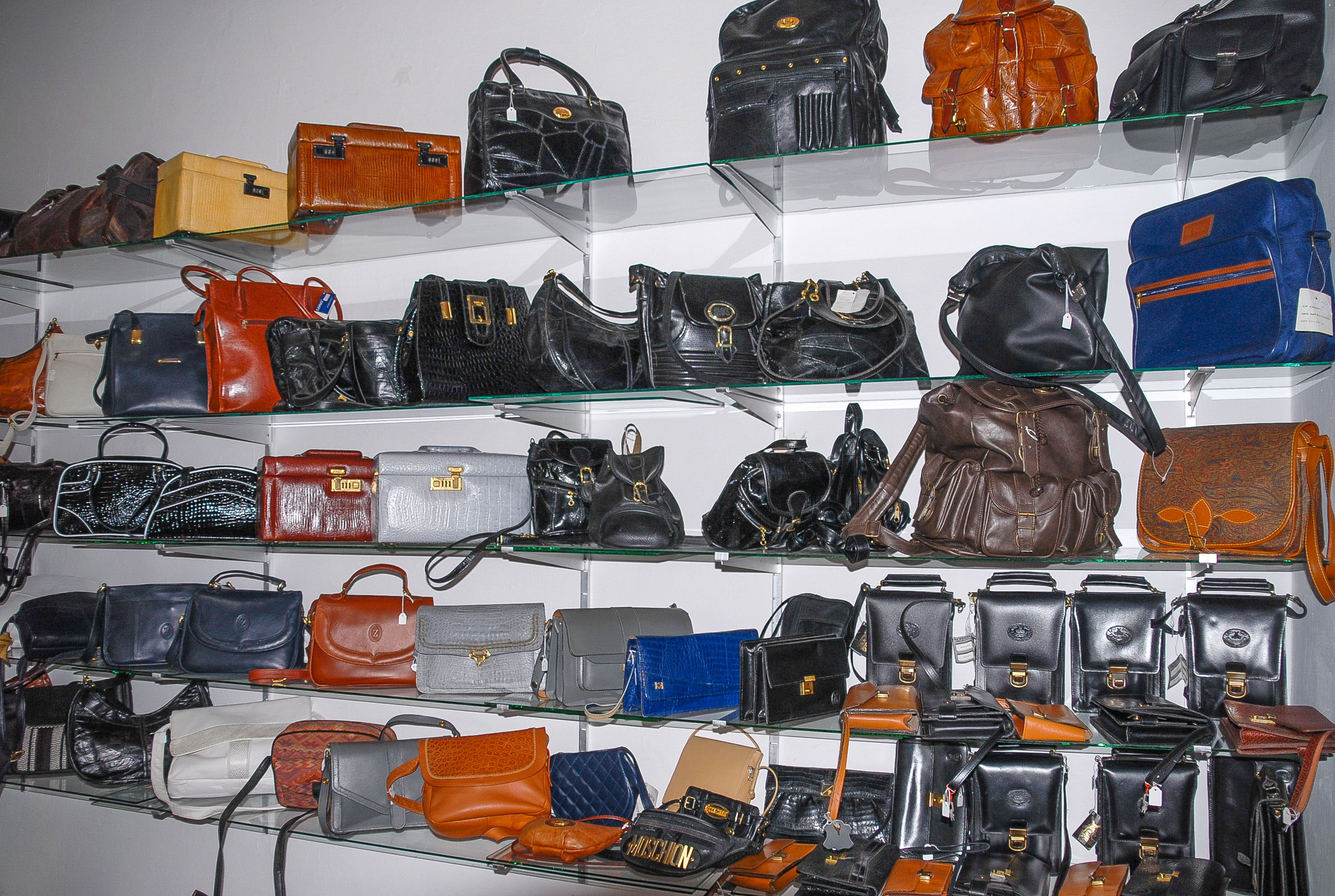 Handbags displayed on boutique shelves