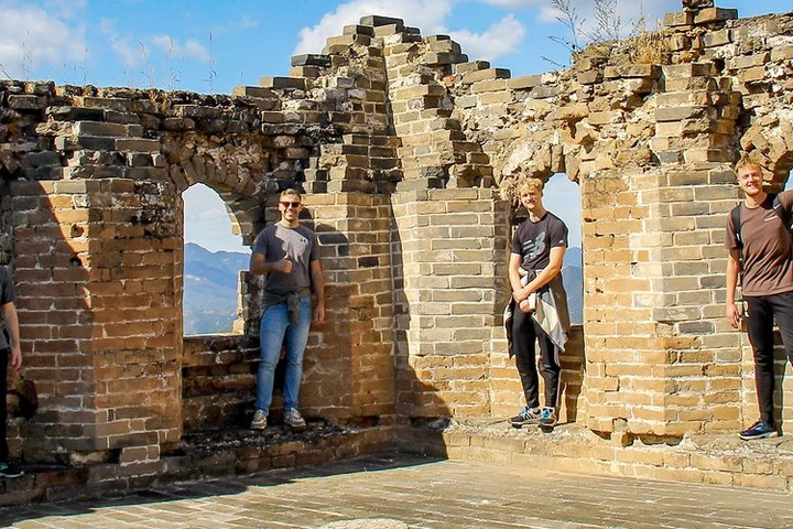 Travelers exploring a Great Wall watchtower near Beijing