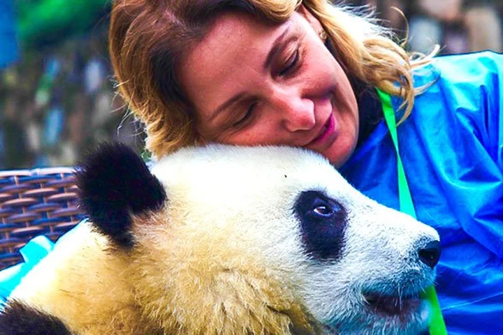 A traveler with a giant panda in Sichuan
